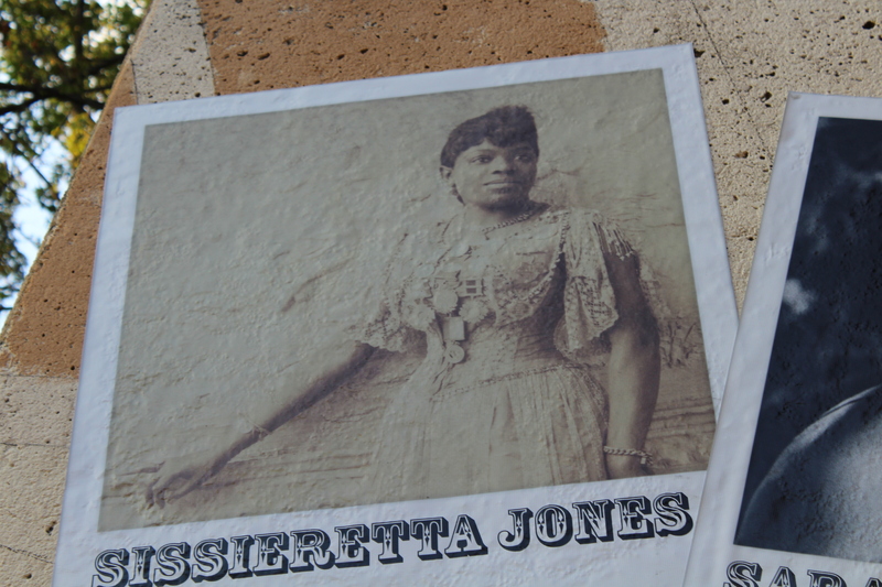 Sepia-toned historical photo of Sissieretta Jones in formal dress, displayed on the music mural.